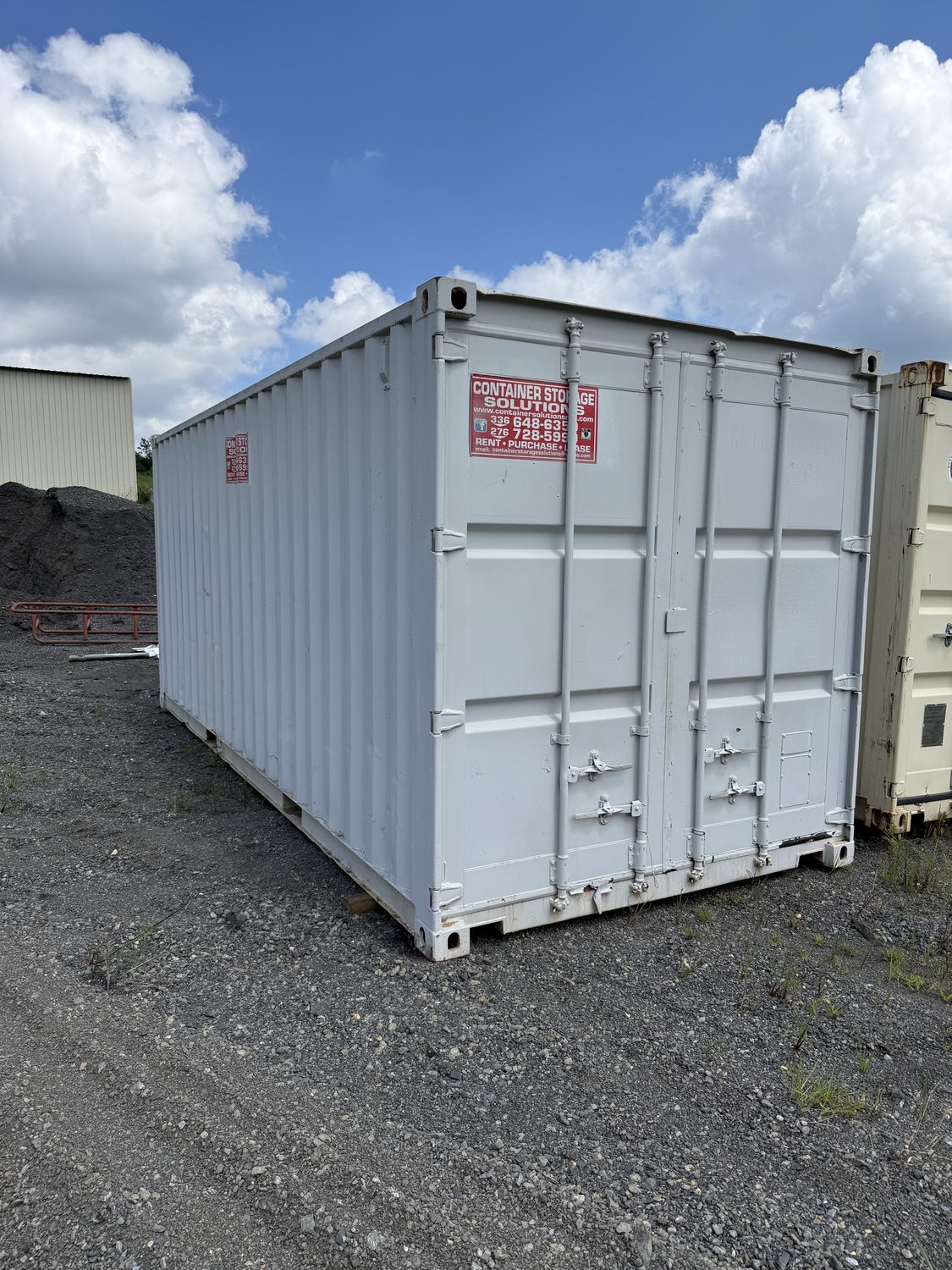 Shipping container modified into a finished workshop with doors and lighting